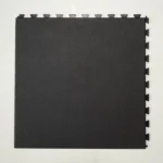 Close-up of black interlocking tile edge and texture