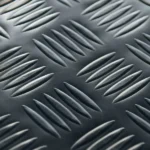 Close-up of black rubber mat with raised oval patterns.