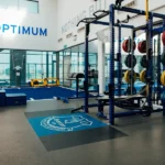 Everton FC weight room with blue squat racks.