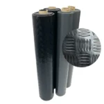 Four rolls of black rubber flooring with texture detail.