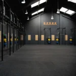 Industrial gym interior with black rubber flooring.