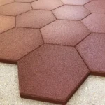 Red hexagonal rubber tiles installed on floor.