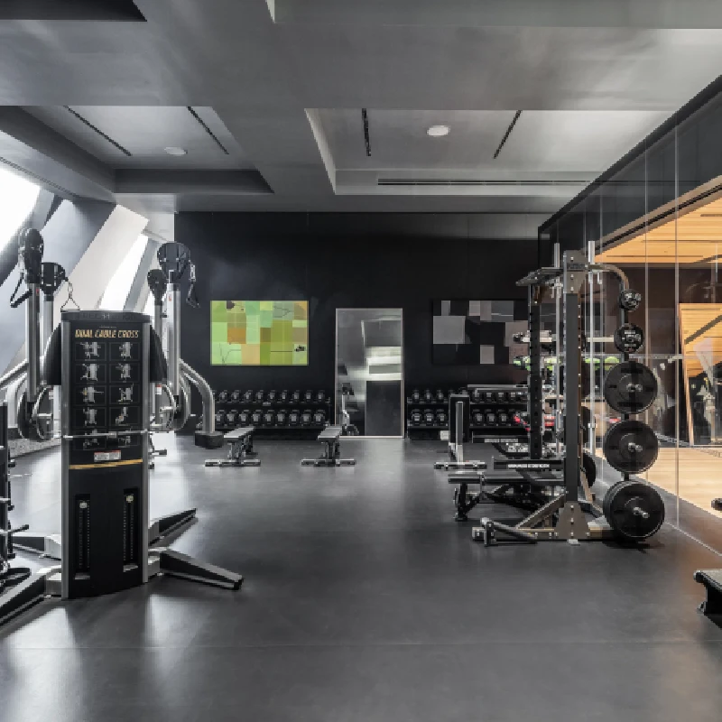Seamless dark gray rubber gym flooring in a modern fitness center.