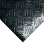 Top-down view of a diamond-plate rubber mat corner.
