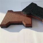 Two red and black dog-bone shaped rubber pavers