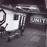 UN1T gym interior with rowers and rubber flooring